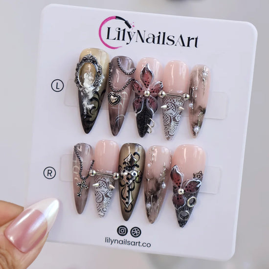 Gothic press on nails in black and nude with 3D crosses, silver metallic details and dark crystal embellishments — handmade Halloween press on nails, long almond fake nails and gothic nail art.