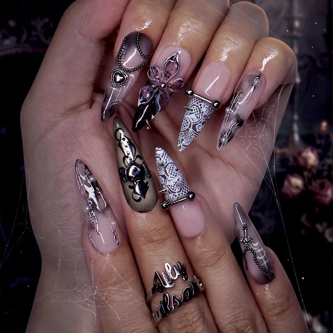 Gothic press on nails in black and nude with 3D crosses, silver metallic details and dark crystal embellishments — handmade Halloween press on nails, long almond fake nails and gothic nail art.