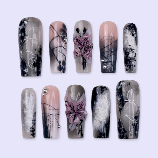 Belladonna gothic press on nails in smoky black and grey over nude with abstract ink marbling, delicate linework and 3D mauve-pink lilies — handmade Halloween press on nails, long square fake nails and gothic nail art.