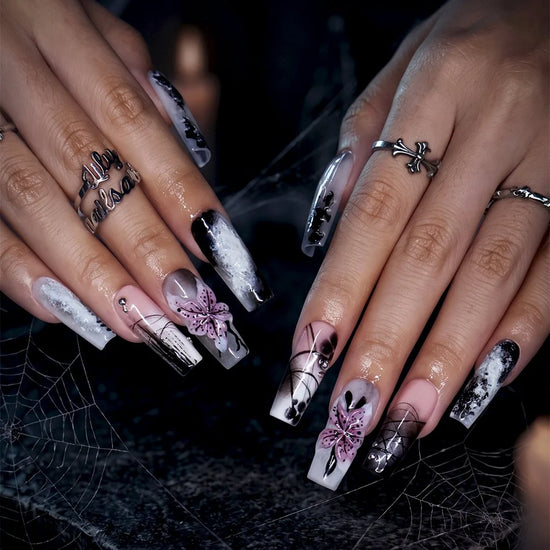 Belladonna gothic press on nails in smoky black and grey over nude with abstract ink marbling, delicate linework and 3D mauve-pink lilies — handmade Halloween press on nails, long square fake nails and gothic nail art.