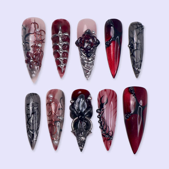 Velvet Bite gothic press on nails in blood red, black and smoky grey with a 3D spider, spiderwebs, black rose, silver studs and thorny vines — handmade Halloween press on nails, long stiletto fake nails and vampire gothic nail art.