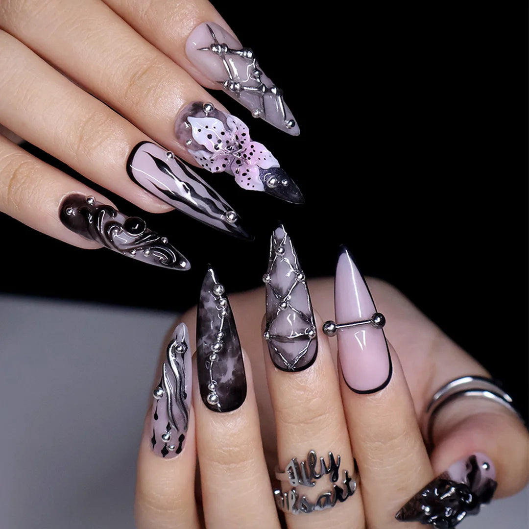 Enigma gothic press on nails in smoky mauve-grey, black and nude with silver piercings, chain lattice, black lace, baroque swirls and a 3D purple lily — handmade Halloween press on nails, long stiletto fake nails and gothic nail art.
