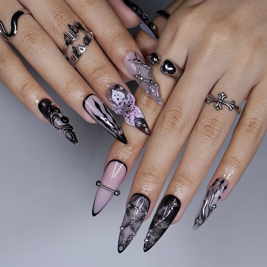 Enigma gothic press on nails in smoky mauve-grey, black and nude with silver piercings, chain lattice, black lace, baroque swirls and a 3D purple lily — handmade Halloween press on nails, long stiletto fake nails and gothic nail art.