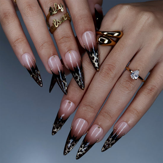 Prowl fall press on nails in nude with black and gold leopard-print French tips and delicate gold bead accents — handmade designer press on nails, long almond fake nails and animal print nail art.