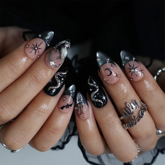 Eclipse gothic Halloween press on nails in nude, smoky black and silver chrome with a 3D snake, spiderwebs, bat, stars and crescent moon — handmade designer press on nails, medium almond fake nails and celestial witchy nail art.