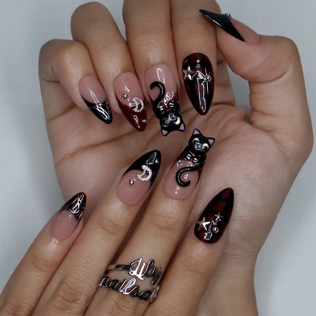 Meow gothic Halloween press on nails in nude, dark red and black with adorable 3D black cats, rhinestone moons, silver stars, spiderwebs and plaid accents — handmade designer press on nails, medium almond fake nails and cute witchy nail art.