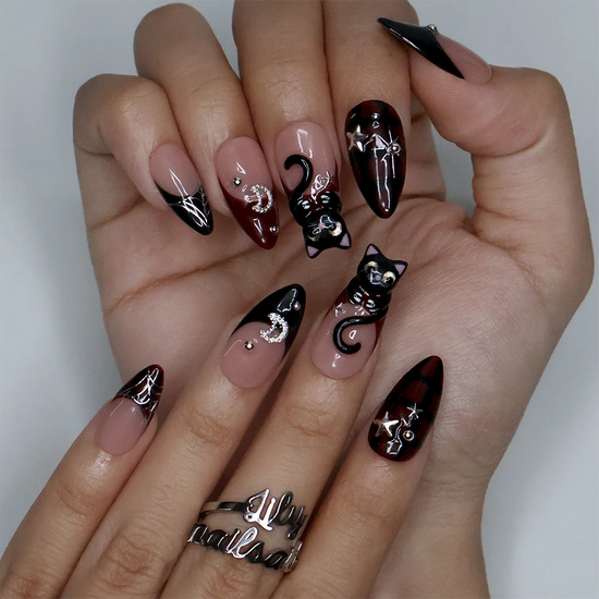 Meow gothic Halloween press on nails in nude, dark red and black with adorable 3D black cats, rhinestone moons, silver stars, spiderwebs and plaid accents — handmade designer press on nails, medium almond fake nails and cute witchy nail art.