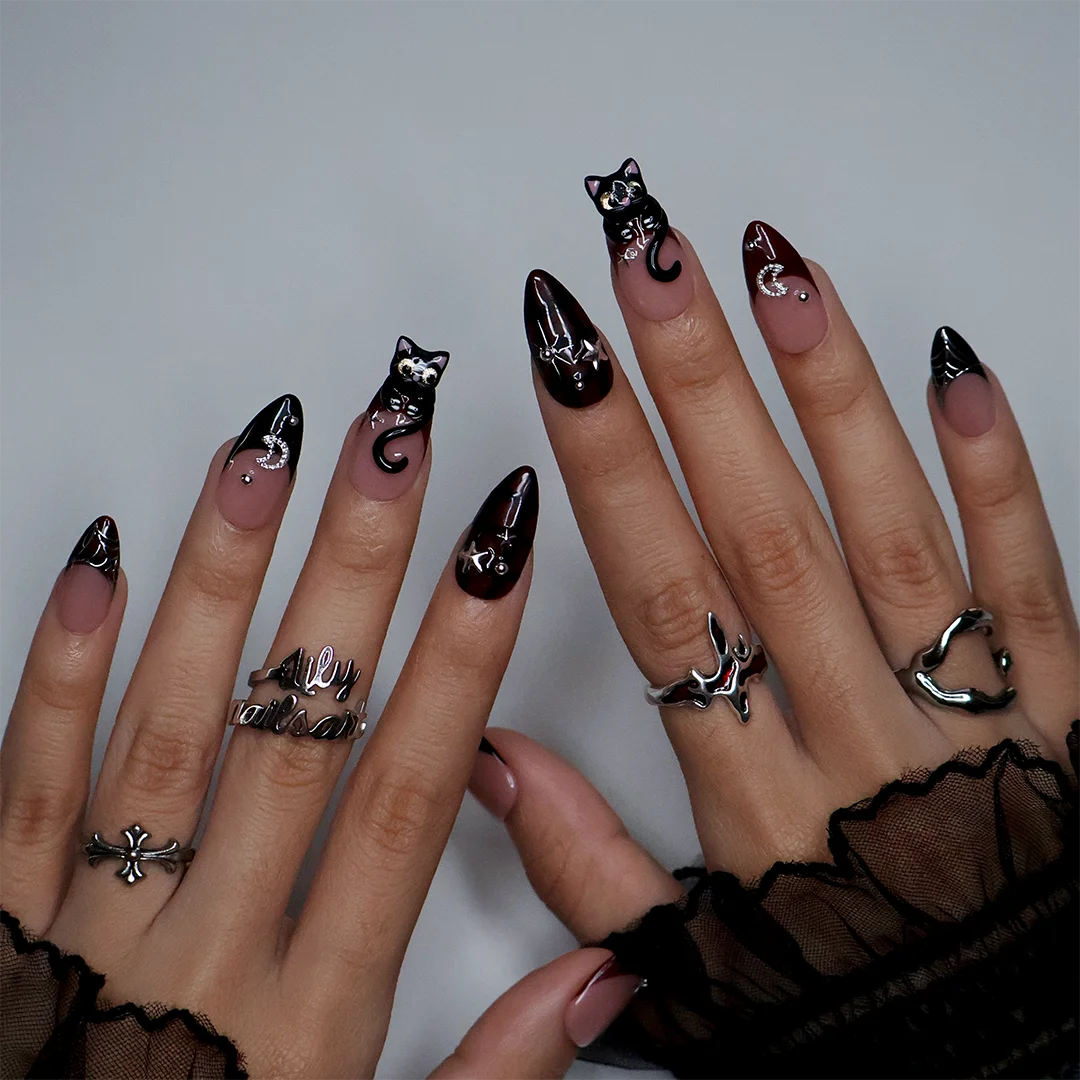 Meow gothic Halloween press on nails in nude, dark red and black with adorable 3D black cats, rhinestone moons, silver stars, spiderwebs and plaid accents — handmade designer press on nails, medium almond fake nails and cute witchy nail art.