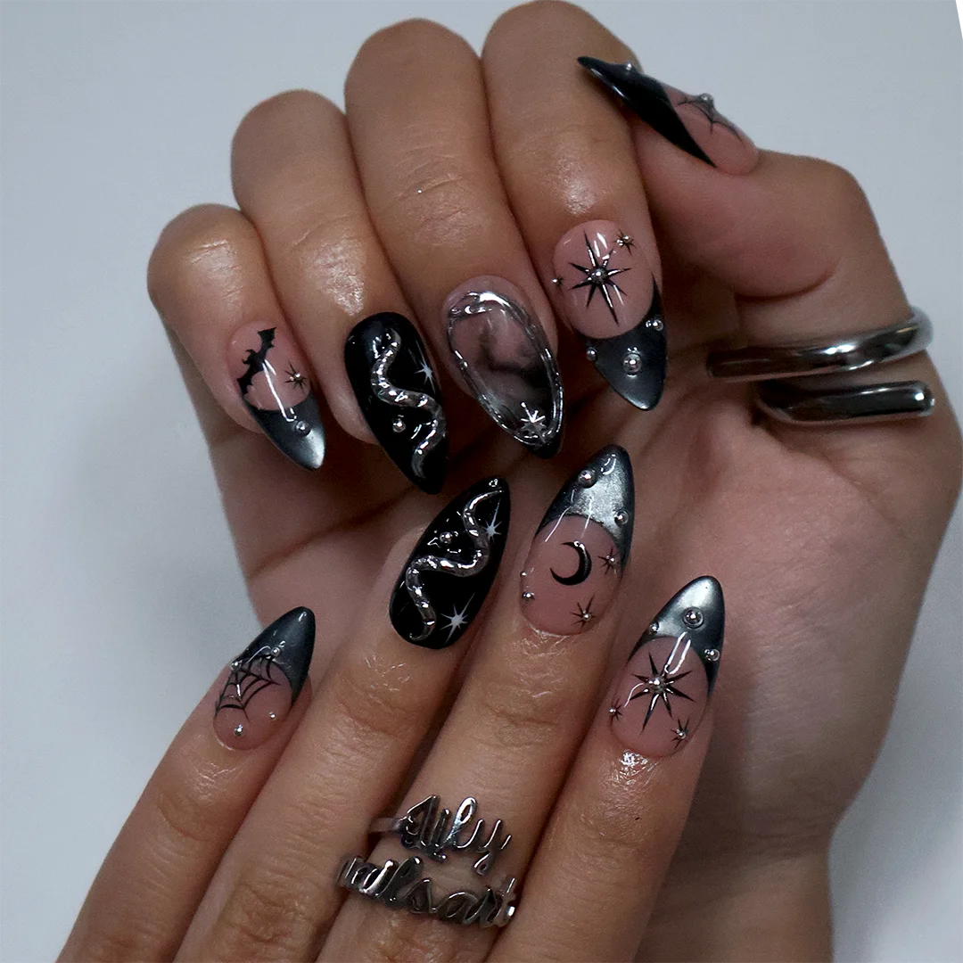 Eclipse gothic Halloween press on nails in nude, smoky black and silver chrome with a 3D snake, spiderwebs, bat, stars and crescent moon — handmade designer press on nails, medium almond fake nails and celestial witchy nail art.
