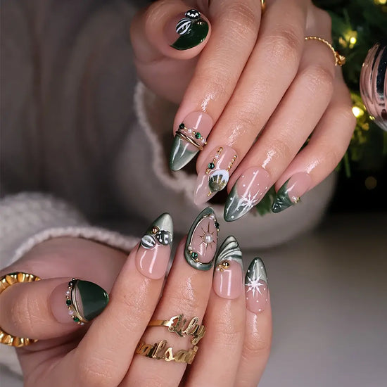 Emerald Eve handmade Christmas press-on nails — medium almond set in nude and sage-green cat-eye with 3D Christmas ornament baubles, gold starbursts, pearls, emerald gemstones and delicate snowflake accents.