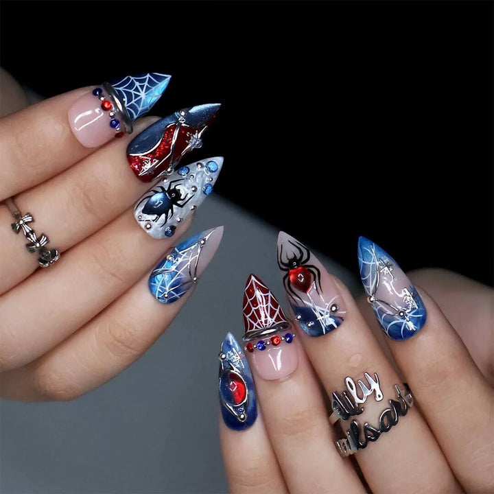 Arachnova handmade gothic Halloween press-on nails — medium stiletto set in blood-red, midnight blue, black and nude with 3D spiders, silver spiderwebs, celestial stars and jewel accents.