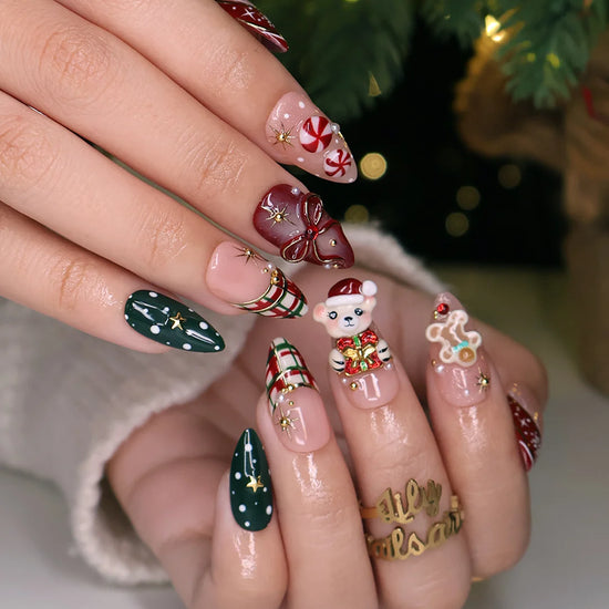Gingerbread handmade Christmas press-on nails — medium almond set in nude, red and green with a 3D Santa-hat teddy bear, gingerbread man, peppermint candies, red and green plaid, snowflakes, gold stars and bow accents.