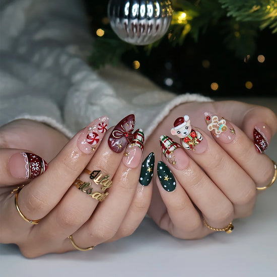 Gingerbread handmade Christmas press-on nails — medium almond set in nude, red and green with a 3D Santa-hat teddy bear, gingerbread man, peppermint candies, red and green plaid, snowflakes, gold stars and bow accents.