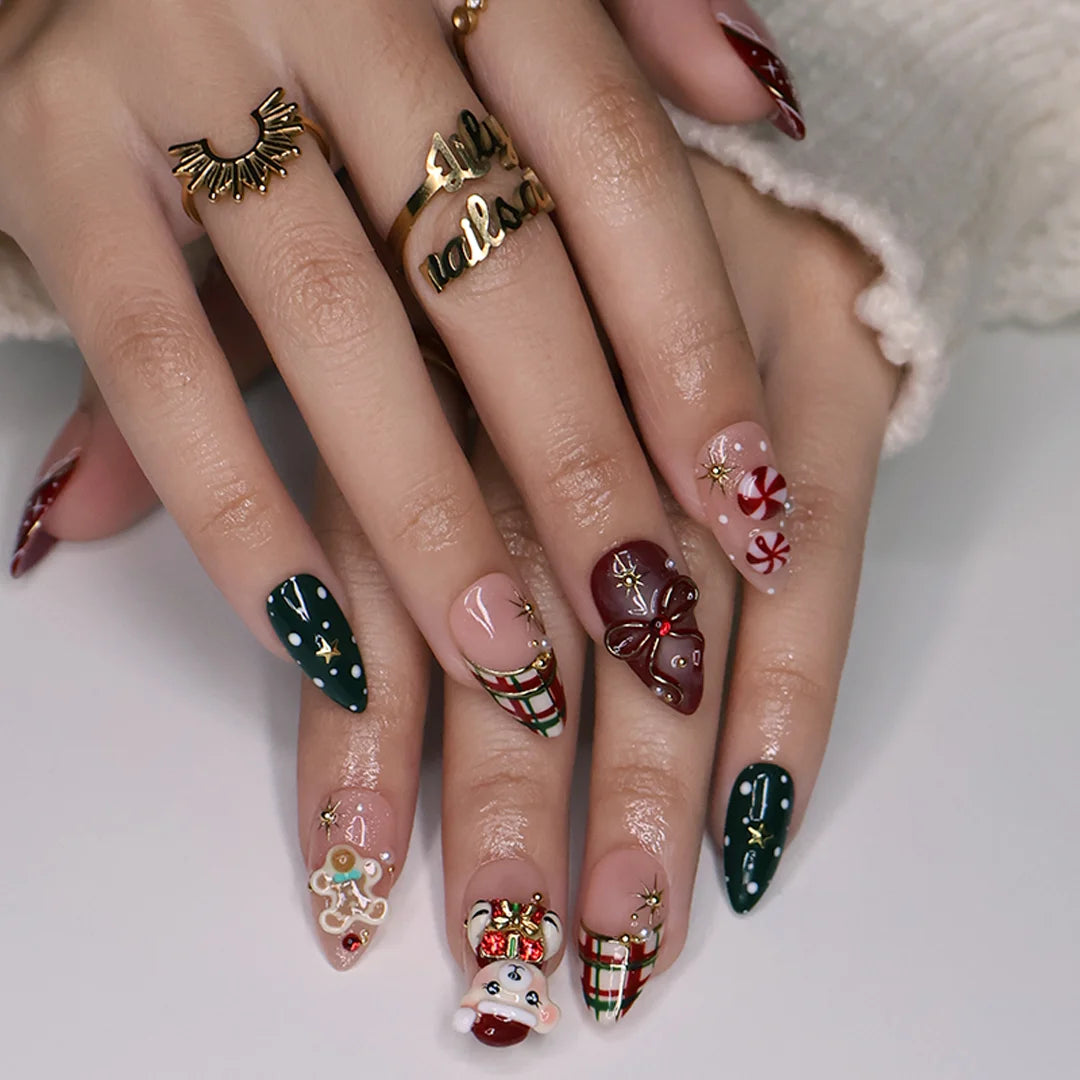 Gingerbread handmade Christmas press-on nails — medium almond set in nude, red and green with a 3D Santa-hat teddy bear, gingerbread man, peppermint candies, red and green plaid, snowflakes, gold stars and bow accents.