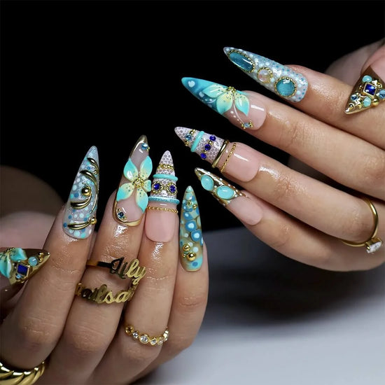 a hand model wearing Handmade summer press-on nails — maximalist long almond set  in tiffany blue with sapphire gems, gold filigree and aqua 3D lilies