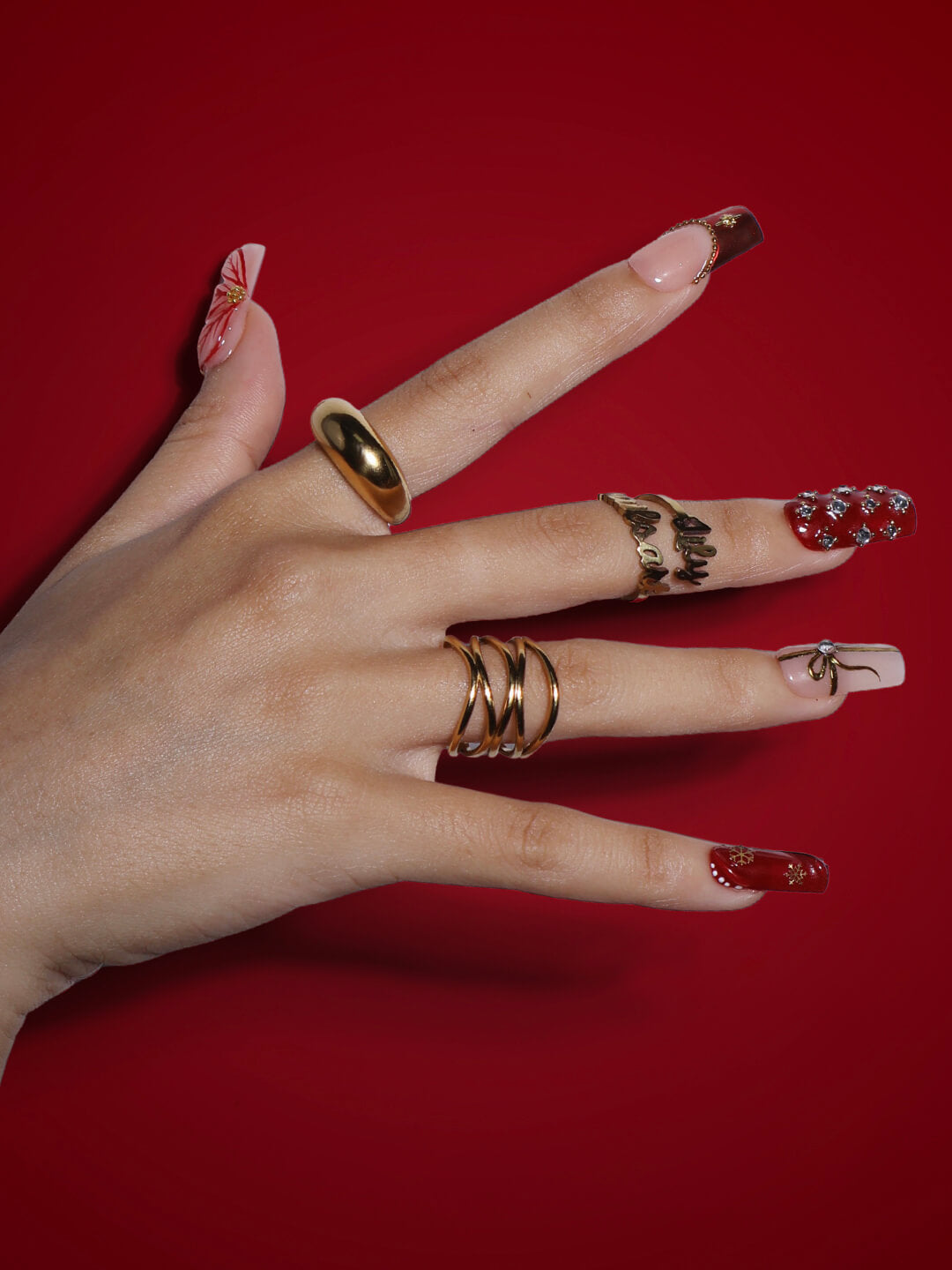 3D red & nude press on nails in medium square with christmas tree, gold charms, snowflakes, and poinsettia details — luxury handmade false nails, reusable press ons for holiday, Christmas party, and festive gifts