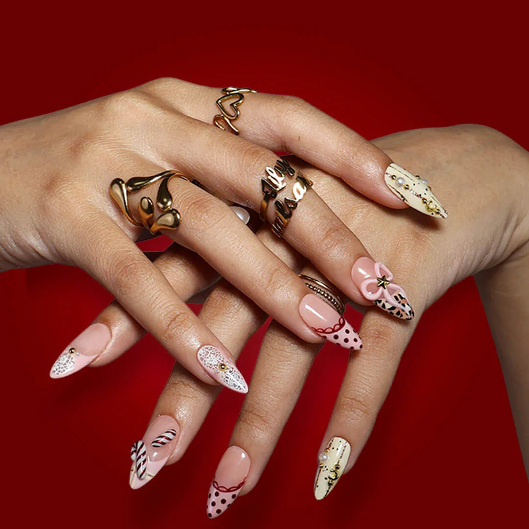 3D pink leopard print press on nails with red candy cane, gold bow, and peppermint swirl accents — handmade Christmas 2025 nails, festive fake nails, holiday nail art