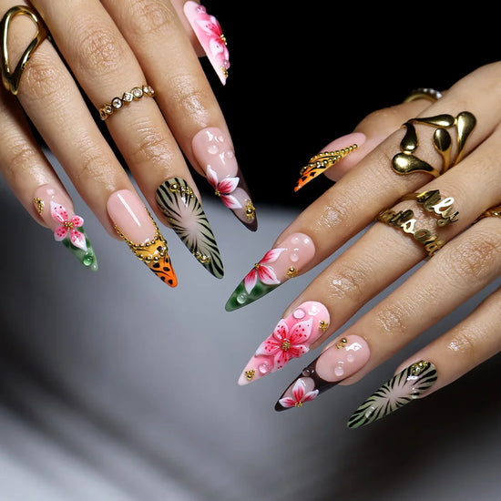 hand model wearing Green & pink handmade summer press-on nails — maximalist long almond set with tiger and zebra print, 3D pink lilies and gold beading
