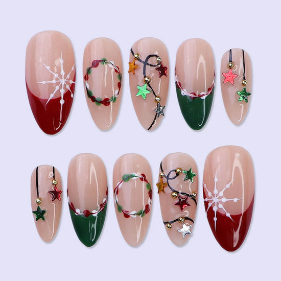 3D Christmas press on nails with red and green French tips, embellished with star garlands, metallic charms, and hand-painted snowflakes — festive holiday fake nails, reusable false nails, handmade nail art, custom pressons for winter, party or gift ideas