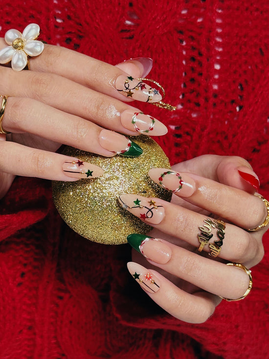 3D Christmas press on nails with red and green French tips, embellished with star garlands, metallic charms, and hand-painted snowflakes — festive holiday fake nails, reusable false nails, handmade nail art, custom pressons for winter, party or gift ideas