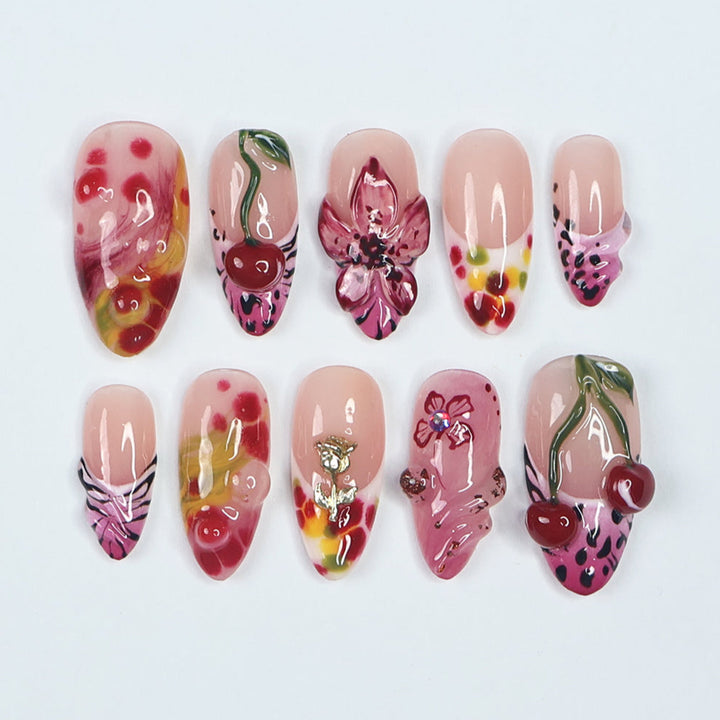 Vibrant designer press-on nails with a playful mix of cherry, floral, and abstract watercolor designs. Featuring 3D sculpted cherries, intricate hand-painted flowers, and glossy pink and red hues, these premium, reusable press-on nails provide a salon-quality alternative to Kiss and Glamour Press-On Nails. Perfect for those who love bold, artistic, and trendy nail designs. Shop high-quality custom press-on nails for a unique, long-lasting manicure