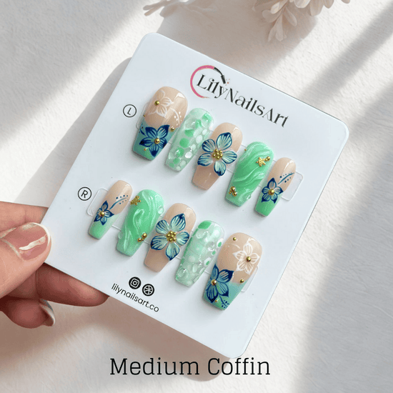 3D mint green press on nails with hand-painted navy and white flowers, sculpted petals, swirl textures, and glossy bubble accents — featuring tropical floral designs, soft gradients, and gold embellishments — summer press on nails, handmade floral nail art, fake nails, false nails, pressons — perfect for beach holidays, breezy summer looks, or gifting for her.