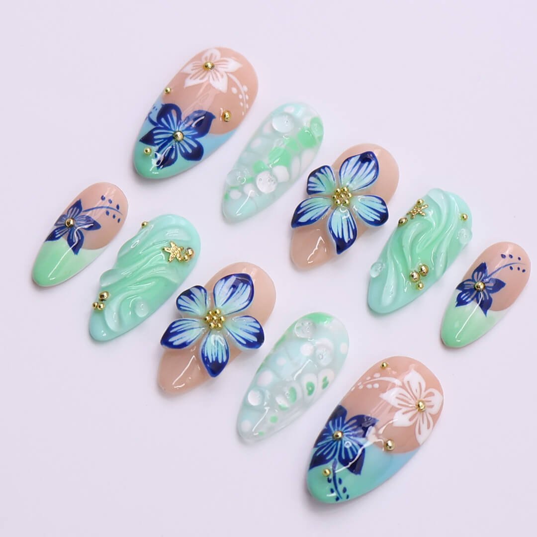 3D mint green press on nails with hand-painted navy and white flowers, sculpted petals, swirl textures, and glossy bubble accents — featuring tropical floral designs, soft gradients, and gold embellishments — summer press on nails, handmade floral nail art, fake nails, false nails, pressons — perfect for beach holidays, breezy summer looks, or gifting for her.