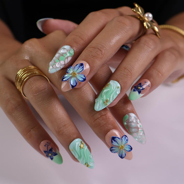 3D mint green press on nails with hand-painted navy and white flowers, sculpted petals, swirl textures, and glossy bubble accents — featuring tropical floral designs, soft gradients, and gold embellishments — summer press on nails, handmade floral nail art, fake nails, false nails, pressons — perfect for beach holidays, breezy summer looks, or gifting for her.