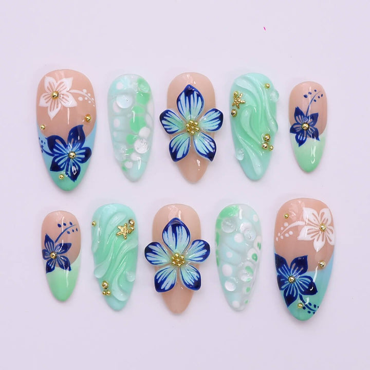 3D mint green press on nails with hand-painted navy and white flowers, sculpted petals, swirl textures, and glossy bubble accents — featuring tropical floral designs, soft gradients, and gold embellishments — summer press on nails, handmade floral nail art, fake nails, false nails, pressons — perfect for beach holidays, breezy summer looks, or gifting for her.