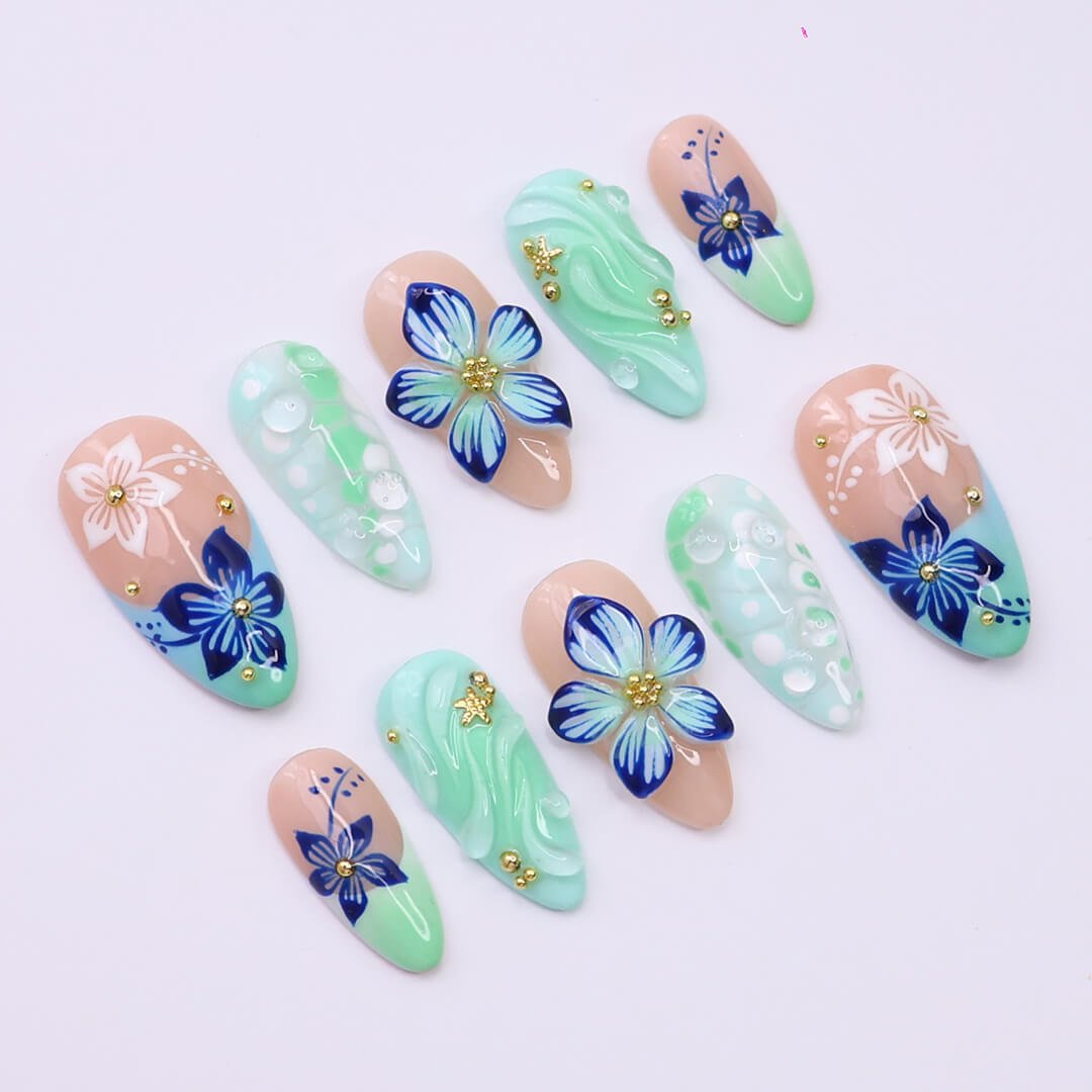 3D mint green press on nails with hand-painted navy and white flowers, sculpted petals, swirl textures, and glossy bubble accents — featuring tropical floral designs, soft gradients, and gold embellishments — summer press on nails, handmade floral nail art, fake nails, false nails, pressons — perfect for beach holidays, breezy summer looks, or gifting for her.