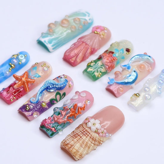 3D ocean press on nails with dolphins, seahorse, starfish, coral reef, and tropical flowers — featuring vibrant colors, glitter seashells, pearl bubbles, and sculpted textures — beach vacation nails, mermaid core press on nails, custom handmade nail art, fake nails, false nails, pressons — perfect for summer getaways, tropical looks, or gifting for ocean lovers.