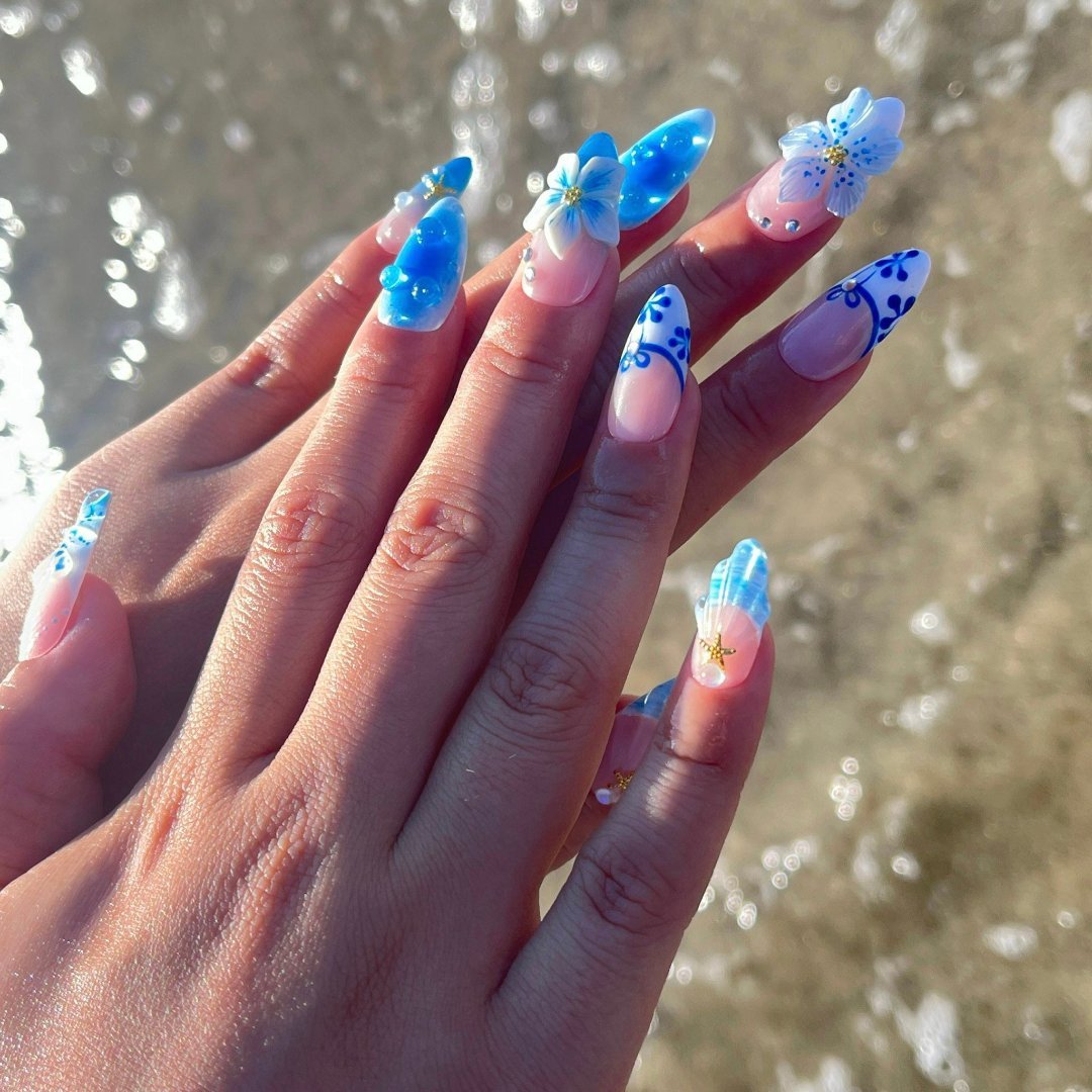 3D blue press on nails with ocean waves, starfish, seashells, and floral accents — luxury handmade summer nails for beach days and vacations.