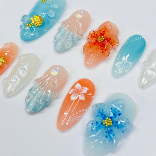 Handmade Tropical Ocean Press-On Nails – vibrant blue and coral tones with 3D seashells, flowers, starfish, and pearl accents. Perfect for  summer holidays, birthdays, vacations, or as a unique gift for her.