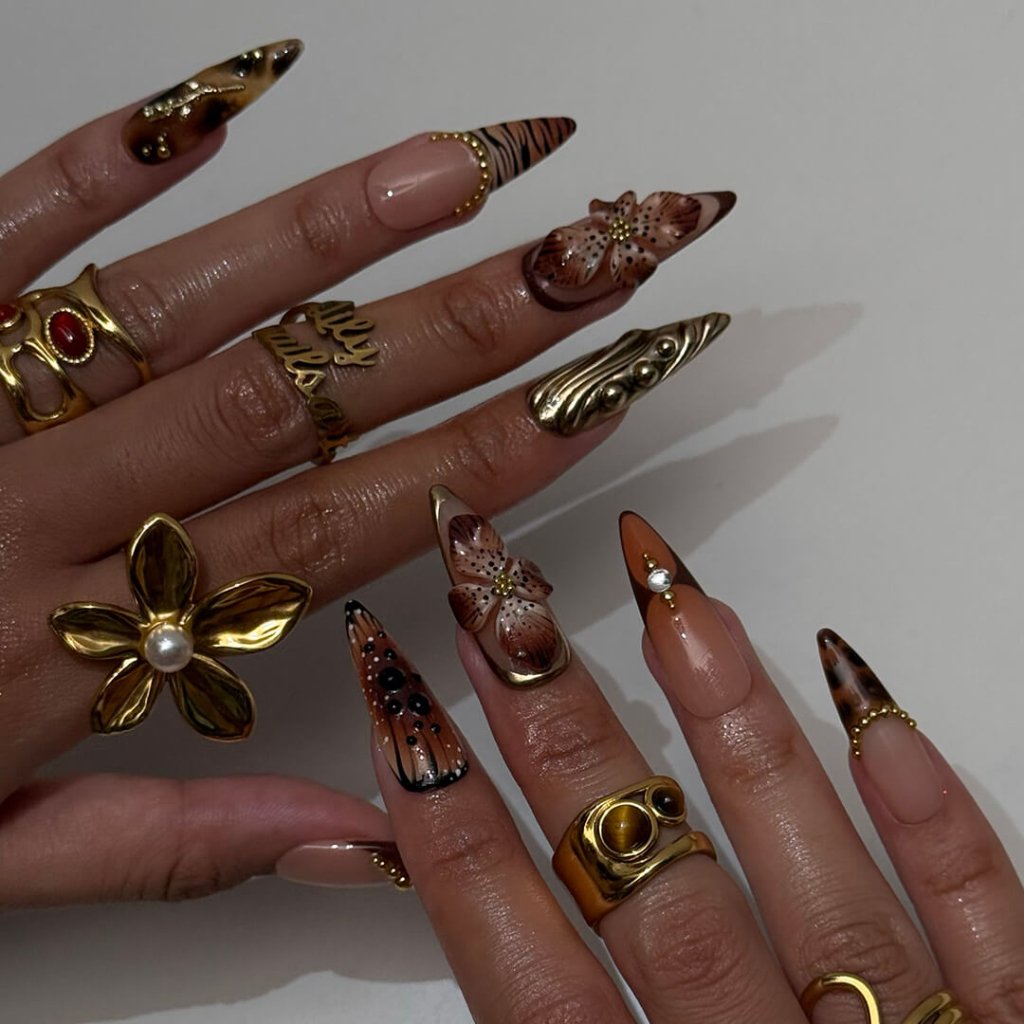 Luxury press-on nails with animal print, 3D floral designs, gold accents, and deep amber tones — handmade long stiletto nails — perfect for jungle-inspired nails, luxury statement nail art, and bold elegant looks.