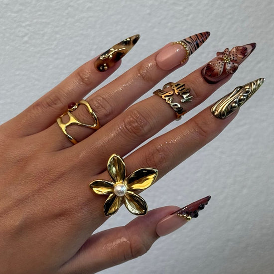 Luxury press-on nails with animal print, 3D floral designs, gold accents, and deep amber tones — handmade long stiletto nails — perfect for jungle-inspired nails, luxury statement nail art, and bold elegant looks.