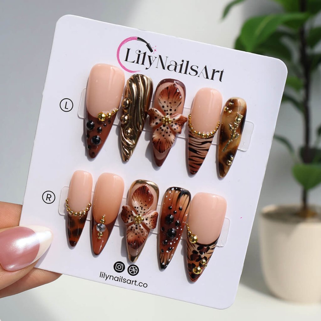 Luxury press-on nails with animal print, 3D floral designs, gold accents, and deep amber tones — handmade long stiletto nails — perfect for jungle-inspired nails, luxury statement nail art, and bold elegant looks.
