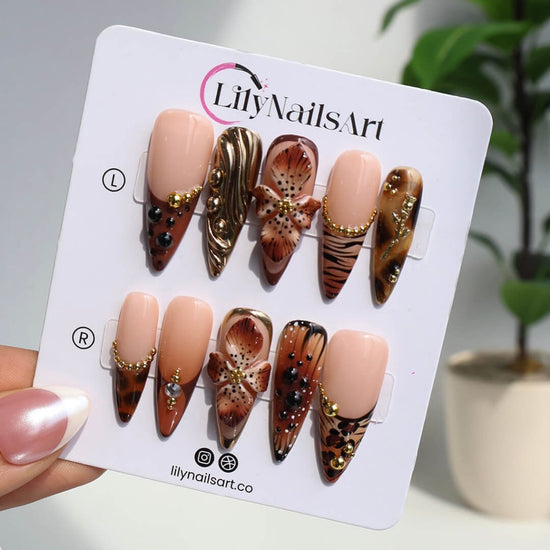 Luxury press-on nails with animal print, 3D floral designs, gold accents, and deep amber tones — handmade long stiletto nails — perfect for jungle-inspired nails, luxury statement nail art, and bold elegant looks.