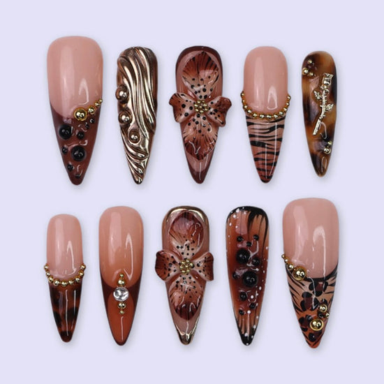 Luxury press-on nails with animal print, 3D floral designs, gold accents, and deep amber tones — handmade long stiletto nails — perfect for jungle-inspired nails, luxury statement nail art, and bold elegant looks.