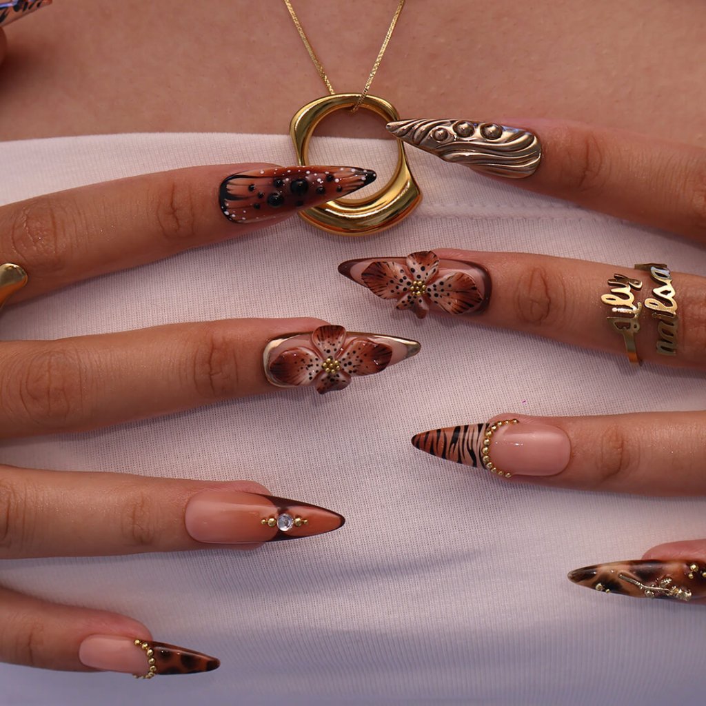 Luxury press-on nails with animal print, 3D floral designs, gold accents, and deep amber tones — handmade long stiletto nails — perfect for jungle-inspired nails, luxury statement nail art, and bold elegant looks.
