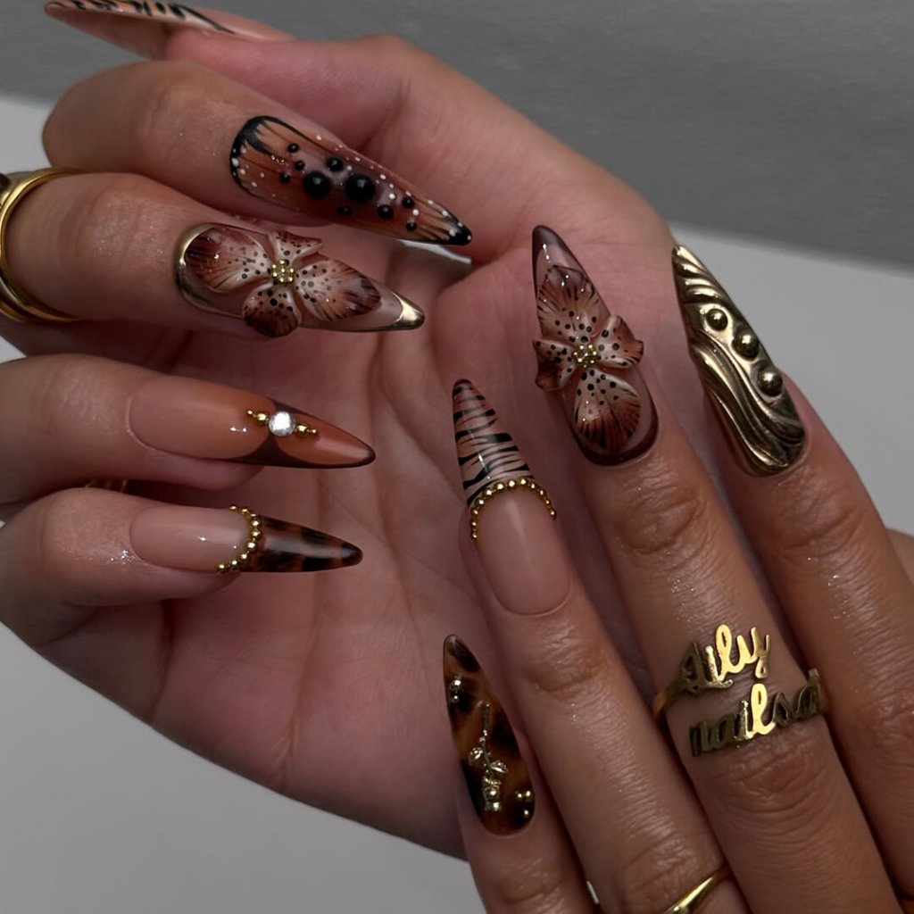 Luxury press-on nails with animal print, 3D floral designs, gold accents, and deep amber tones — handmade long stiletto nails — perfect for jungle-inspired nails, luxury statement nail art, and bold elegant looks.