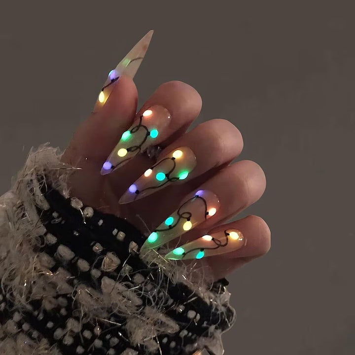 Handmade Christmas press on nails with colorful glowing light string design on stiletto shape — custom holiday nails, luxury fake nails, festive party nail art for Christmas looks and winter events.