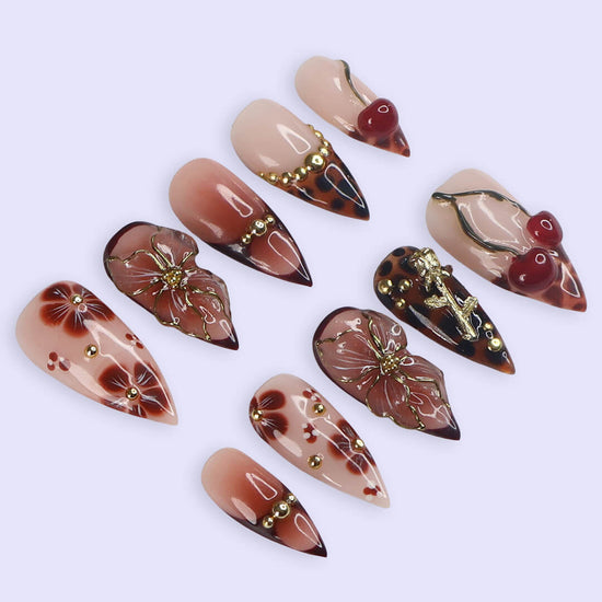 Medium stiletto press on nails with red cherry accents, 3D floral designs, tortoiseshell tips, and gold embellishments — luxury handmade false nails for date nights, self-expression, or gifting. Custom press on nails, reusable nail art, fake nails for beauty lovers.