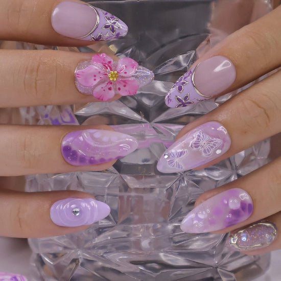 3D purple and lavender press on nails with butterfly art, pink sakura flowers, glossy swirls, and crystal bow charms — custom press on nails, luxury handmade nail art, fake nails, false nails, pressons — perfect for spring, summer, romantic gifts, or soft aesthetic lovers