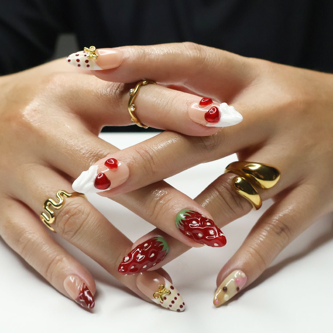 Adorable strawberry-themed designer press-on nails featuring 3D sculpted strawberries, whipped cream accents, and gold bow embellishments. These kawaii-inspired, salon-quality press-on nails offer a sweet and playful look, perfect for food lovers and trendy nail enthusiasts. A premium, reusable alternative to Kiss and Glamour Press-On Nails. Shop custom, high-quality press-on nails for a fun, long-lasting manicure.