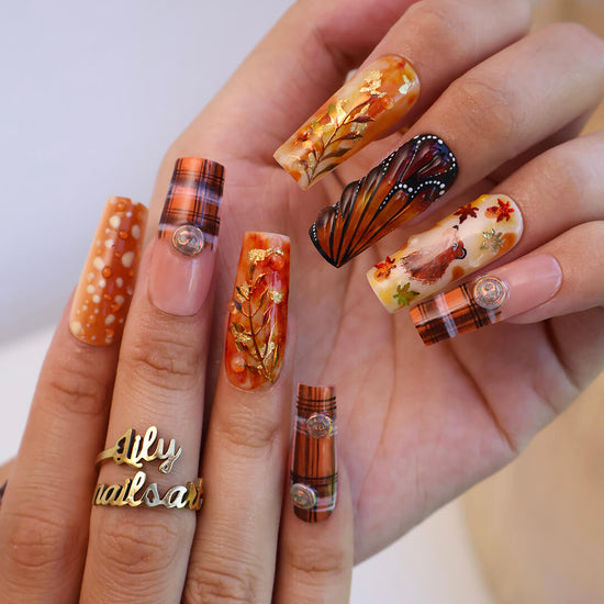 Luxury press-on nails with plaid patterns, golden foil leaves, tortoiseshell swirls, and warm caramel tones — handmade long almond nails — perfect for fall-inspired nail art, luxury everyday style, or elegant seasonal looks.