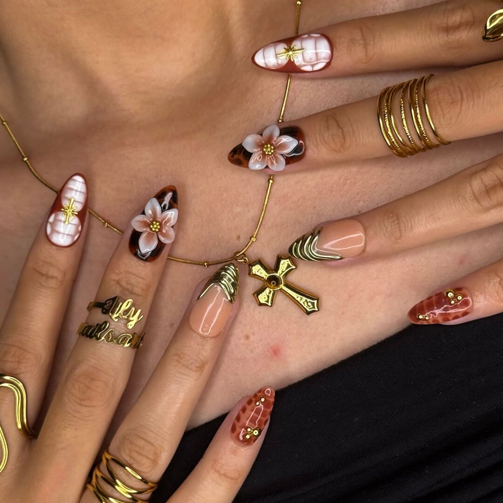 Luxury press-on nails with tortoiseshell patterns, 3D florals, and gold metallic accents on warm amber and nude bases — handmade medium almond nails — perfect for elegant everyday wear, chic autumn looks, or timeless luxury nail art.