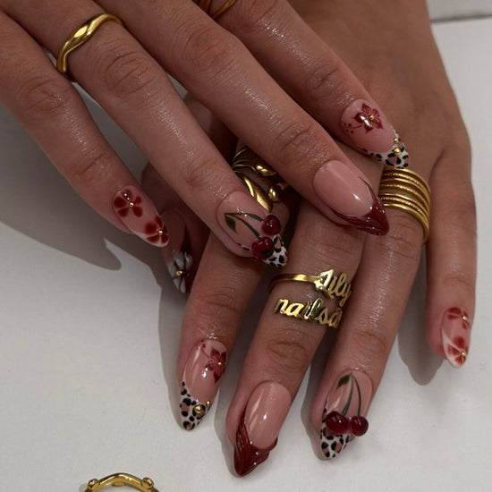 Cherry red press-on nails with hand-painted florals, subtle leopard accents, and glossy crimson tips — luxury handmade medium almond nails  — perfect for elegant  fall everyday looks, romantic evenings