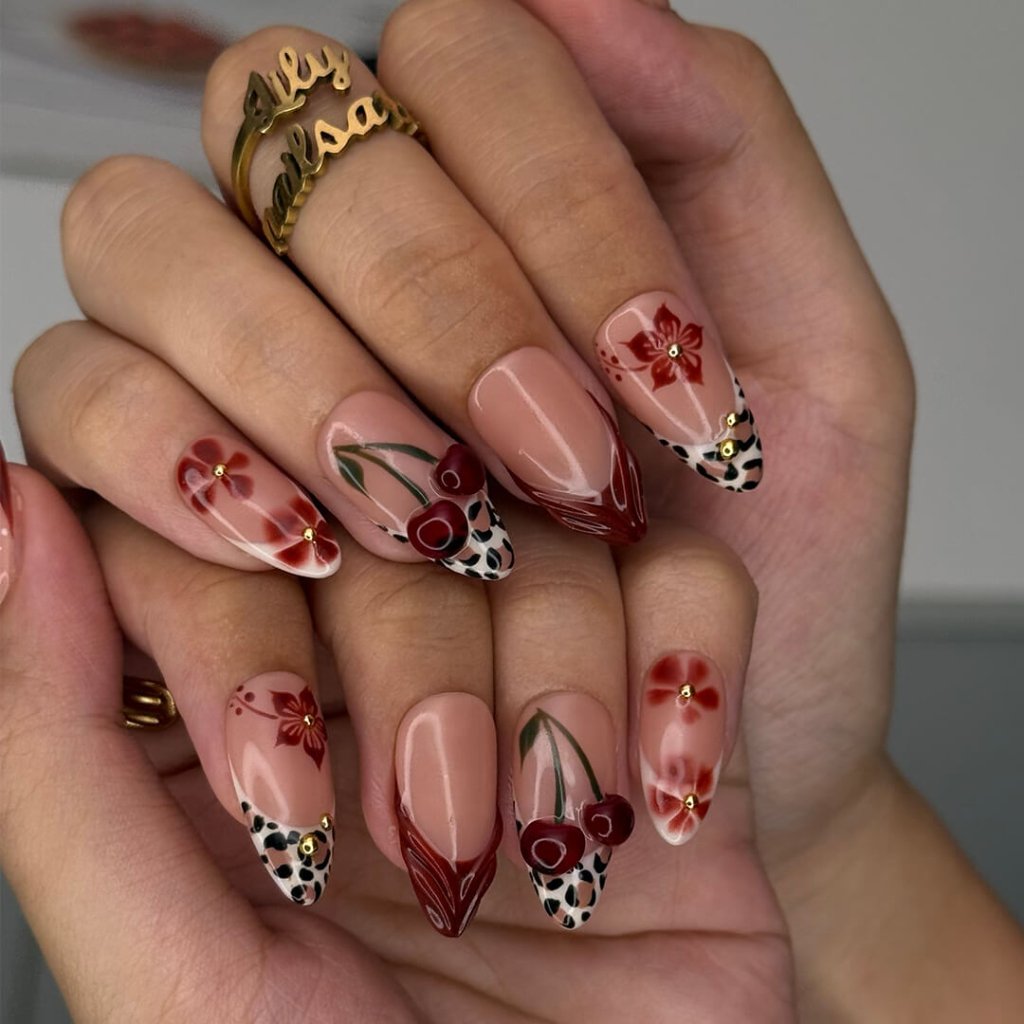 Cherry red press-on nails with hand-painted florals, subtle leopard accents, and glossy crimson tips — luxury handmade medium almond nails  — perfect for elegant  fall everyday looks, romantic evenings