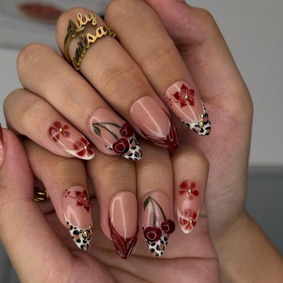 Cherry red press-on nails with hand-painted florals, subtle leopard accents, and glossy crimson tips — luxury handmade medium almond nails  — perfect for elegant  fall everyday looks, romantic evenings