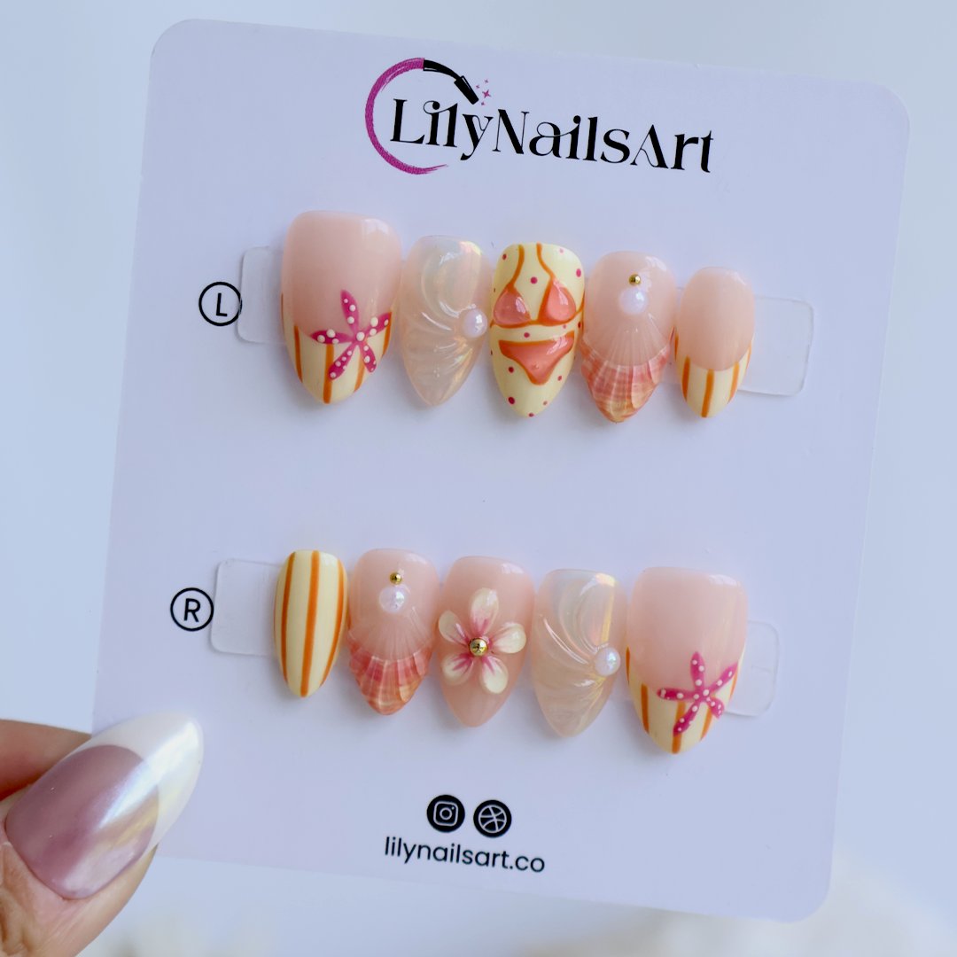 Handmade summer press-on nails with peach base, orange stripes, hand-painted bikini, pink starfish and iridescent seashell shimmer by Lily Nails Art